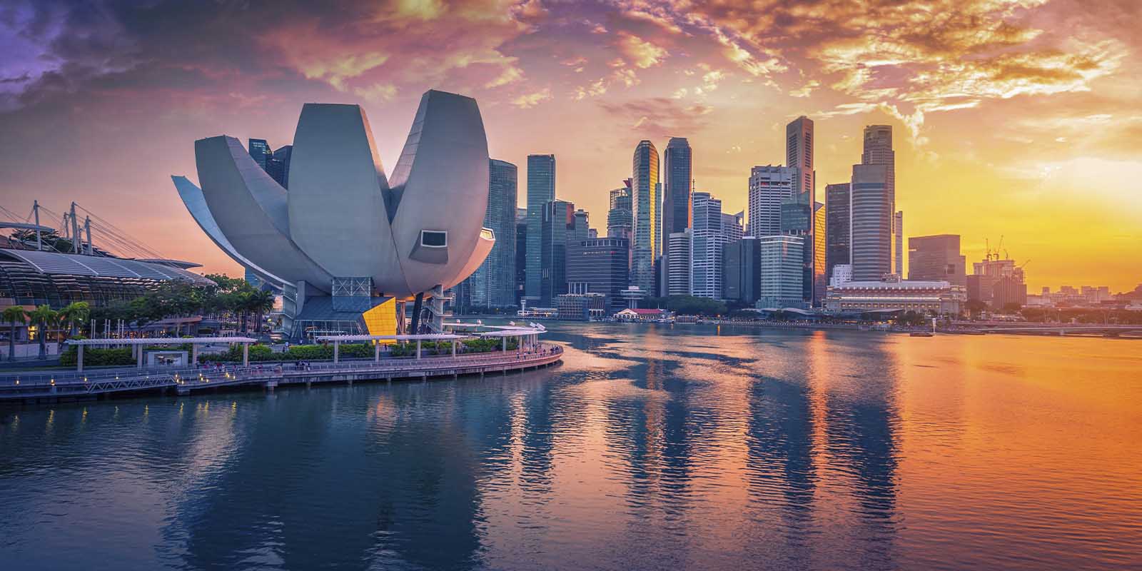 Singapore skyline and view of skyscrapers on marina bay at sunset.