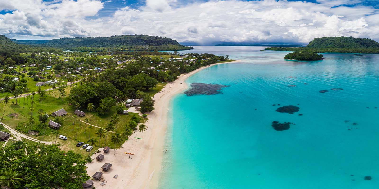 Amazing Port Orly sandy beach with palm trees, Espiritu Santo Island, Vanuatu.